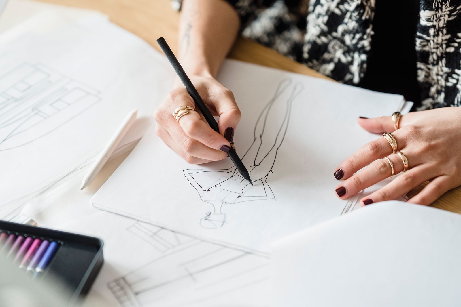 Designer drawing on paper while working on a project
