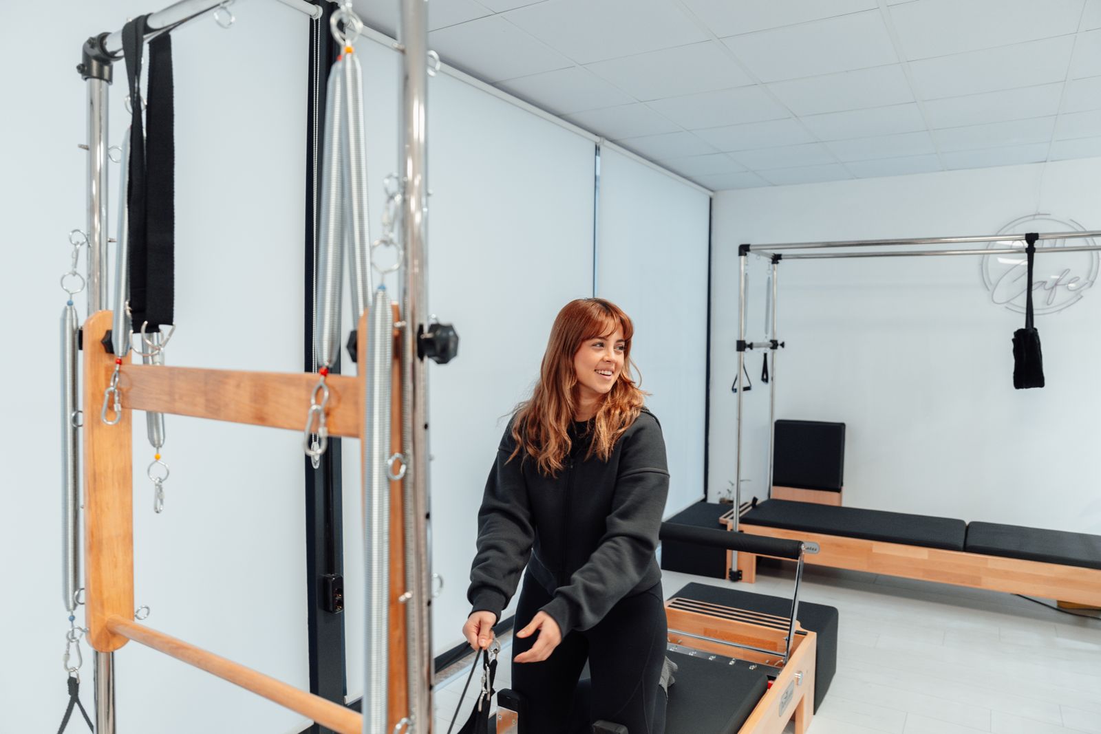 Woman exercising on a pilates tower